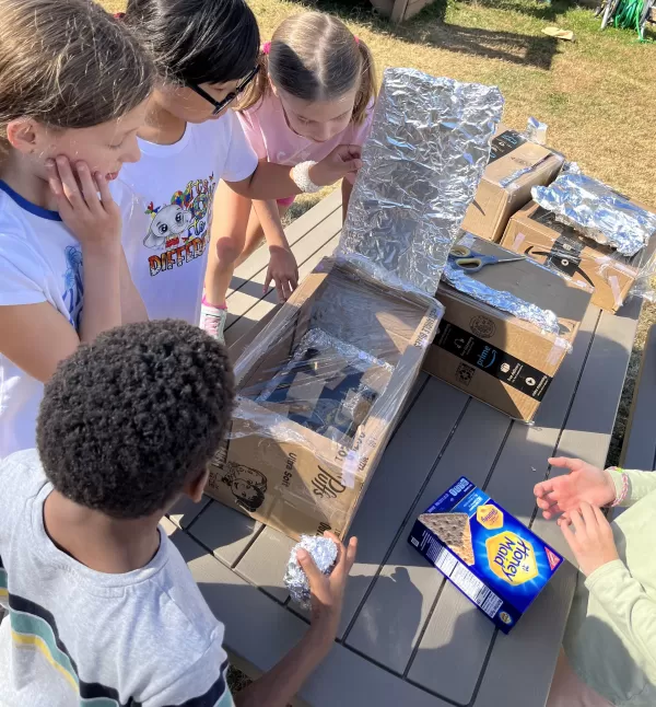 Children conduction a experiment to make outside ovens