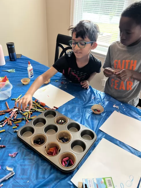 Two boys melting crayons to form new colors